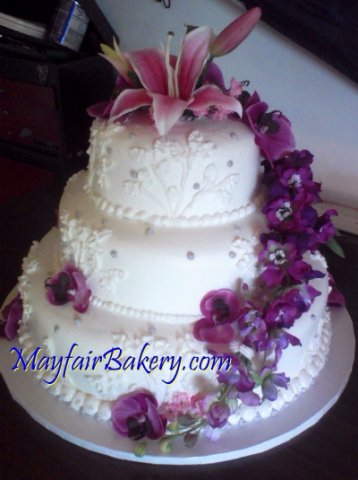 3 Tier 14_22 - 3 tiers with orchid, spray of purple flowers, silver dots, rounded edges.6&quot;, 9&quot;, 12&quot; tiers. 12+ pounds. Serves 60 to 75 people.&amp;nbsp;